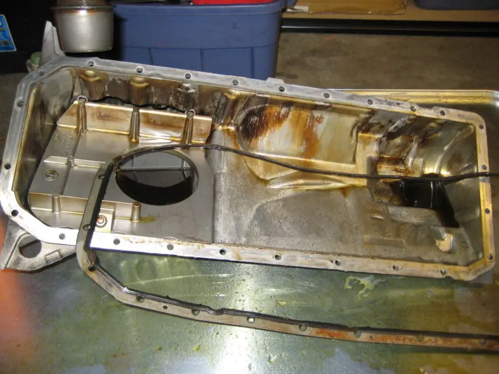 How do you clean an oil pan gasket surface step by step